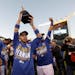 Kansas City Royals' Omar Infante holds the trophy after the Royals defeated the Baltimore Orioles to win the American League baseball championship ser