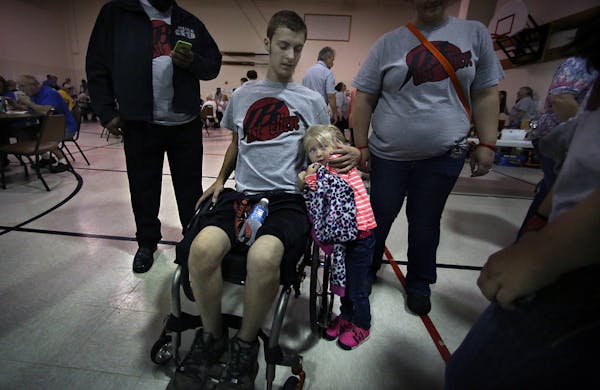 Josh comforted his 4-year-old niece, Kaylee Jensen, during a fundraising event for the family's medical expenses.