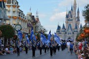 Members of the Woodbury High marching band in a parade at Disney World, one of their events during a trip to Florida.