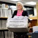 Absentee ballot board judge Peggy Gray brought trays of ballots for processing at the Ramsey County elections office on Monday.