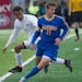 Wayzata's Arthur Parens receives a pass under converage from East Ridge's Kris Broughton during the first half of the Class 2A boys' state soccer semi