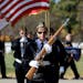 Terri Winter, commander of Fort Snelling National Cemetery's Memorial Rifle Squad, led the color guard back to the bus after one of nine funerals that