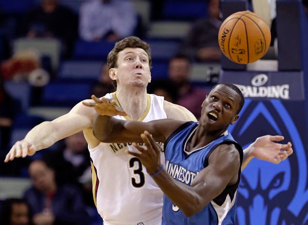 New Orleans Pelicans center Omer Asik (3) and Minnesota Timberwolves center Gorgui Dieng battle for a loose ball in the first half of an NBA basketbal