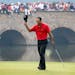 FILE - In this Sunday, Nov. 8, 2009 file photo, Tiger Woods of the United States acknowledges the spectators after he finished the 9th hole during the