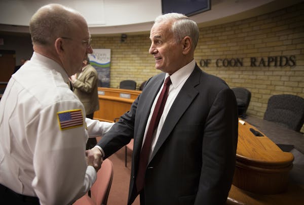 Gov. Mark Dayton spoke with Coon Rapids Fire Chief John Piper after the meeting held Monday to address the issue of trains disturbing traffic flow.