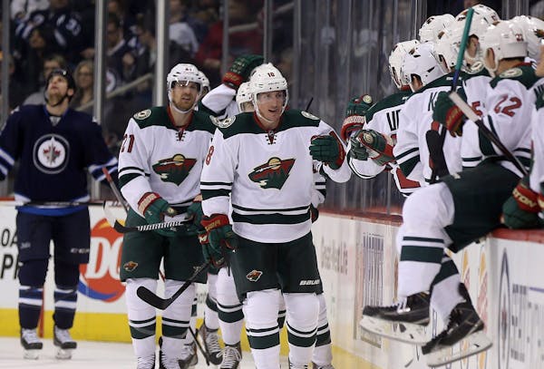 Minnesota Wild's Ryan Carter (18) celebrates after scoring against the Winnipeg Jets during the second period of an NHL hockey game in Winnipeg, Manit