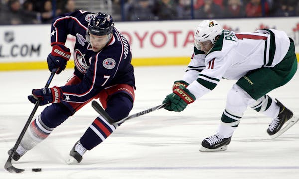 The Wild's Zach Parise, right, tried to steal the puck from the Blue Jackets' Jack Johnson during the second period Wednesday.