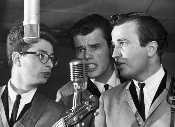 The three surviving Trashmen sharing a microphone circa 1964, photographed for a Minneapolis Tribune cover story that ran just as "Surfin' Bird" was t