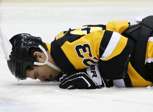 Penguin Steve Downie lay on the ice Tuesday after an elbow from Wild defenseman Ryan Suter, which led to a two-game suspension.
