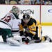 Pittsburgh Penguins' Chris Kunitz (14) gets a shot behind Minnesota Wild goalie Niklas Backstrom (32) for a goal in the second period of an NHL hockey