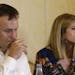 Former Miami Dolphins fullback Rob Konrad, left, listens while his wife Tammy, right, responds to a question during a news conference.
