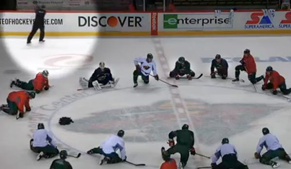 After peppering his team with expletives and sending it to center ice to stretch, Wild coach Mike Yeo (spotlighted) slammed his stick against the visi
