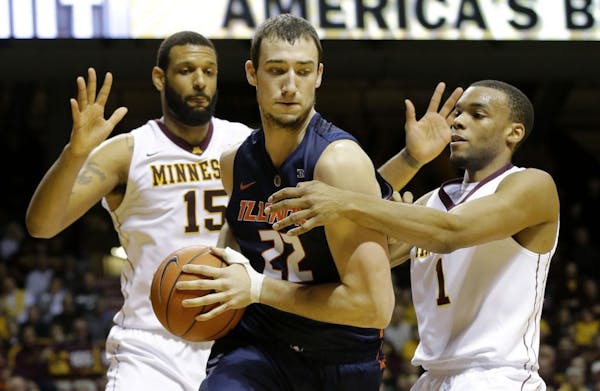 Illinois center Maverick Morgan (22) is trapped by Minnesota forward Maurice Walker (15) and guard Andre Hollins (1) during the first half of an NCAA 