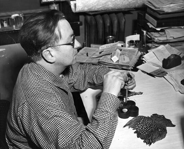 May 1, 1953 George L. Herter, president of Herter's, Inc., Waseca, Minn., sits down to tie himself a few flies for the trout season.