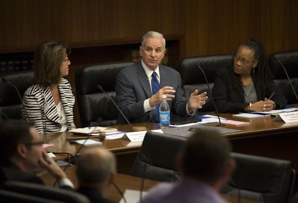 Governor Mark Dayton at the first child protection task force meeting. Co-Chairwomen Commissioner Lucinda Jesson is at left, and Toni Carter is at rig