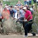 Tiger Woods hits out of the rough on the 11th hole during the first round of the Phoenix Open golf tournament, Thursday, Jan. 29, 2015, in Scottsdale,