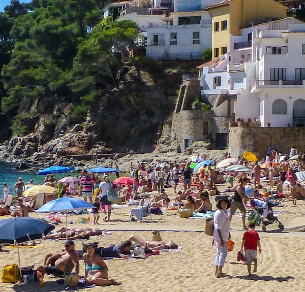 Beach scene in Spain, “the country we most enjoy returning to.”