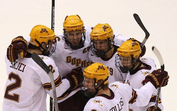 Teammates celebrated with Gopher Christian Isackson after scoring his first goal of the season during the second period.