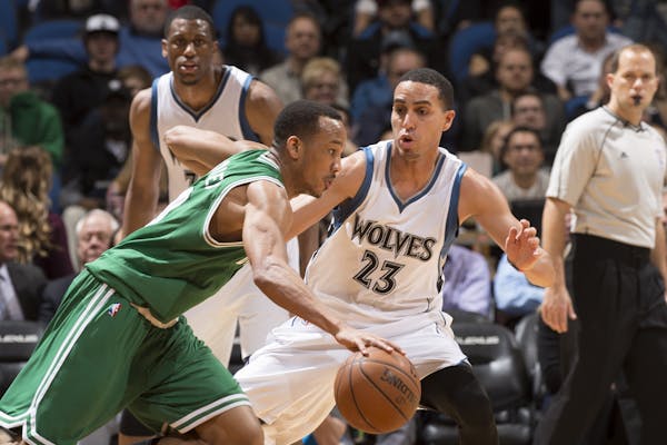 Boston Celtics guard Avery Bradley (0) tries to move the ball around Minnesota Timberwolves guard Kevin Martin (23) during the fourth quarter.