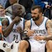 Minnesota Timberwolves forward Kevin Garnett (21) talks to center Nikola Pekovic (14) as he winces in pain on the bench in the second half.