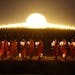Thai Buddhist monks hold candle light gather at Wat Dhammakaya temple in Pathum Thani province to participate in Makha Bucha Day ceremonies Wednesday,