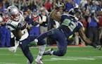 New England Patriots strong safety Malcolm Butler (21) intercepts a pass intended for Seattle Seahawks wide receiver Ricardo Lockette (83) during the 