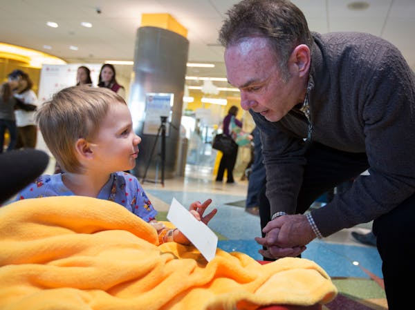 Paul Molitor gave an autographed picture to 3-year-old Decklan Hornstien of Rush City at the Masonic Children’s Hospital.