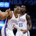 Oklahoma City Thunder guard Russell Westbrook (0) is helped up by teammates Mitch McGary, left, and Dion Waiters (23) during the third quarter of an N