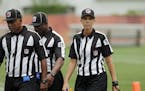FILE - In this June 12, 2014, file photo, Sarah Thomas, right, walks off the field after a Cleveland Browns mandatory minicamp practice at the NFL foo