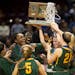 Park Center players celebrate with their championship trophy after defeating Marshall 52-45 in the Class 3A girls' basketball championship game on Sat