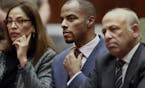 Former NFL safety Darren Sharper, center, with his attorneys, Lisa Wayne, left, and Leonard Levine, right, appear in Los Angeles Superior Court on Mon