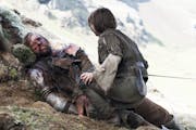 An injured Sandor Clegane, better known as The Hound, portrayed by Rory McCann, left, and Arya Stark, portrayed by Maisie Williams, appear in a scene 