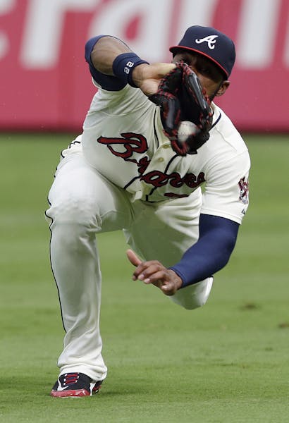 Atlanta Braves right fielder Jason Heyward makes a diving catch to retire Miami Marlins' Adeiny Hechavarria in the first inning of a baseball game in 