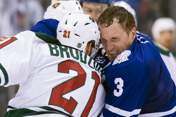The Wild's Kyle Brodziak and the Maple Leafs' Dion Phaneuf glared at each other as they fought during the second period in Toronto on Monday.
