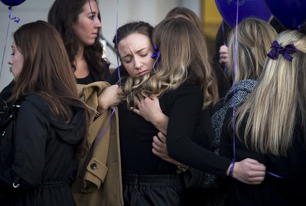 Sisters of Pi Beta Phi embraced each other before the start of Tuesday night's vigil honoring Jennifer Houle,