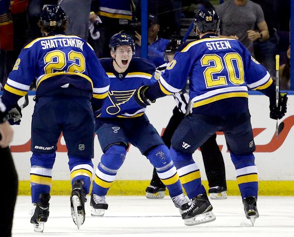 St. Louis Blues' Vladimir Tarasenko, of Russia, is congratulated by teammates Kevin Shattenkirk, left, and Alexander Steen, right, after scoring again