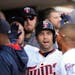 Twins second baseman Brian Dozier was congratulated in the dugout after scoring in the first inning on a Kennys Vargas single Monday afternoon at Targ