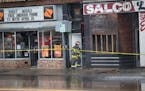Fire fighters continued to to hose water on a fire that broke out on the 900 block of W Broadway in Minneapolis, Minn., on Wednesday, April 15, 2015.