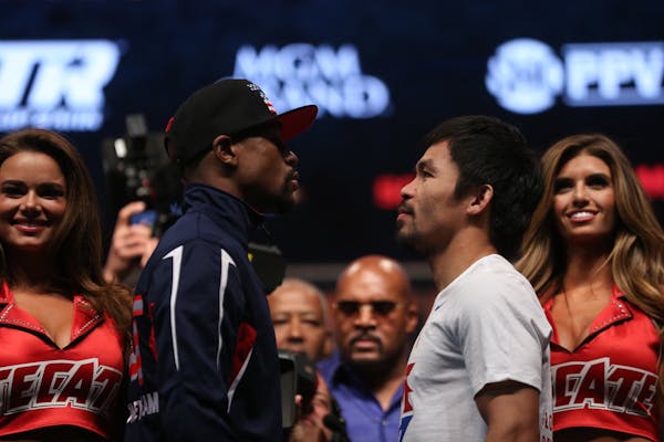 Floyd Mayweather, left, faces Manny Pacquiao shortly after weigh-in at the MGM Grand Garden Arena in Las Vegas on Friday, May 1, 2015. (Robert Gauthie