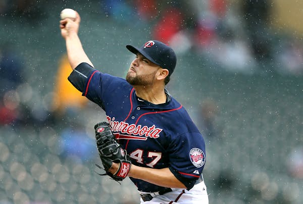 Ricky Nolasco pitches in the rain at Target Field on Thursday afternoon.