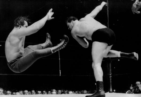October 29, 1953: Verne Gagne, right, lets go with a high fast one in the form of the Mighty Atlas during a match at Madison Square Garden.