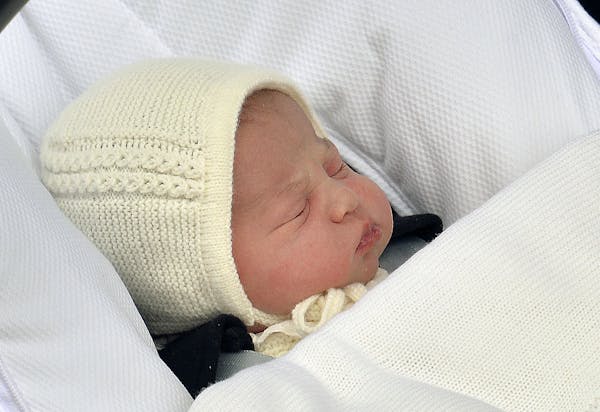 The newborn baby princess, born to parents Kate Duchess of Cambridge and Prince William, is carried in a car seat by her father from The Lindo Wing of