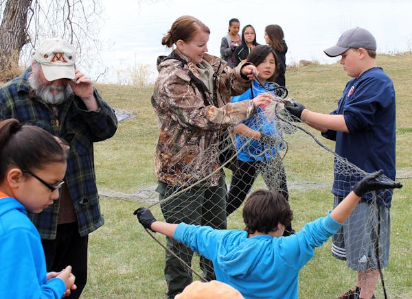 Young Bois Forte members near Lake Vermilion learn about fish netting as part of their education.