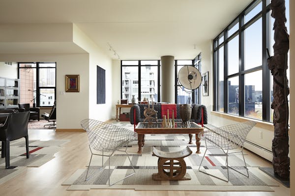 Bruce and Harriet Bart’s Bridgewater Lofts corner condo mixes a modern aesthetic with earthy African artifacts. A tapestry by Harriet covers a wall 