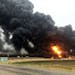 This photo provided by Curt Bemson shows smoke and fire coming from an oil train that derailed Wednesday, May 6, 2015 in Heimdal, North Dakota. Offici