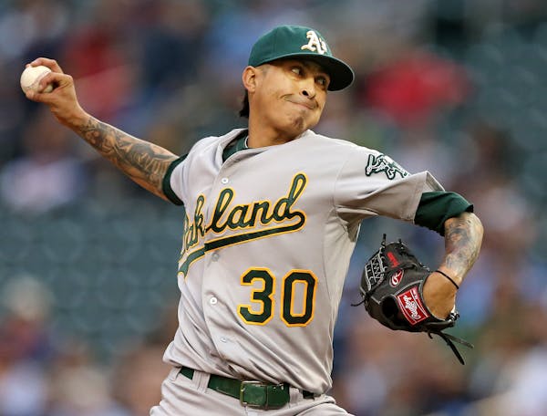 Oakland Athletics pitcher Jesse Chavez (30) threw a pitch in the first inning Tuesday at Target Field.