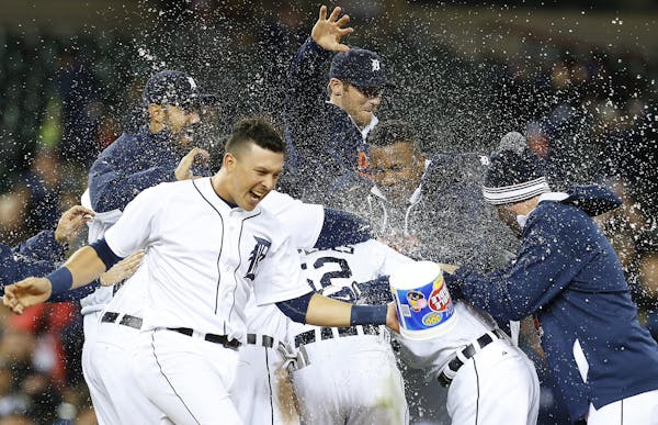 Tigers players began the celebration after Ian Kinsler singled home Anthony Gose with the winning run in the 10th inning.