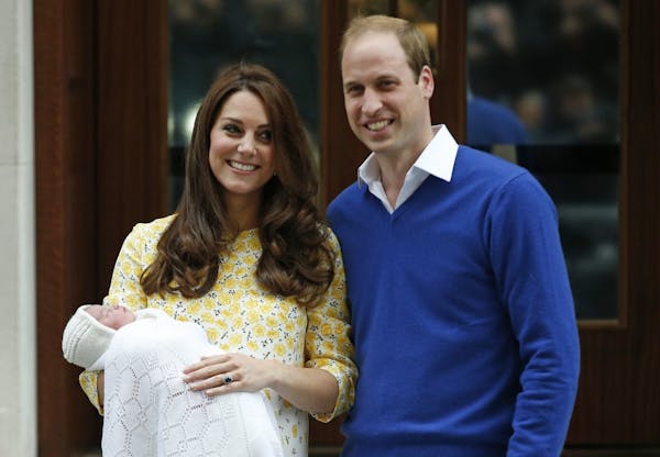 Britain's Prince William and Kate, Duchess of Cambridge and their newborn baby princess, pose for the media as they leave St. Mary's Hospital's exclus