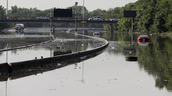 Cars remain stranded along a flooded section of Interstate 45 after heavy rains overnight in Houston, Tuesday, May 26, 2015. Several major highways ar