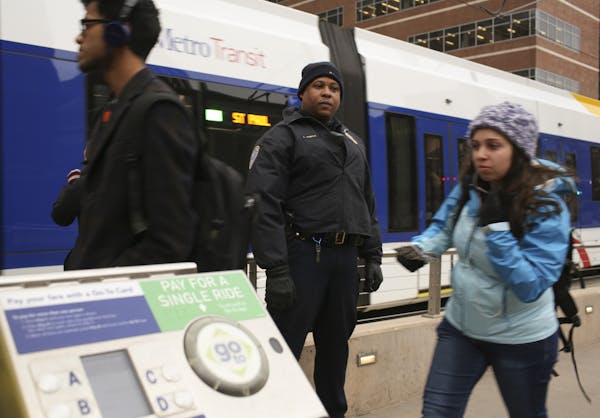 Transit officer LaFayette Temple checked for valid passes or receipts from riders at the East Bank Station Tuesday afternoon in Minneapolis.